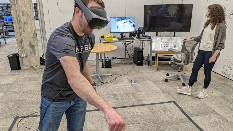 Person using a VR headset and interacting with an object in the VR space