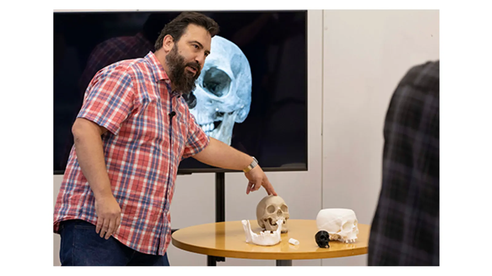 Jeremy Patterson talking about the project with the Ohio Bureau of Criminal Investigation, gesturing at a human skull