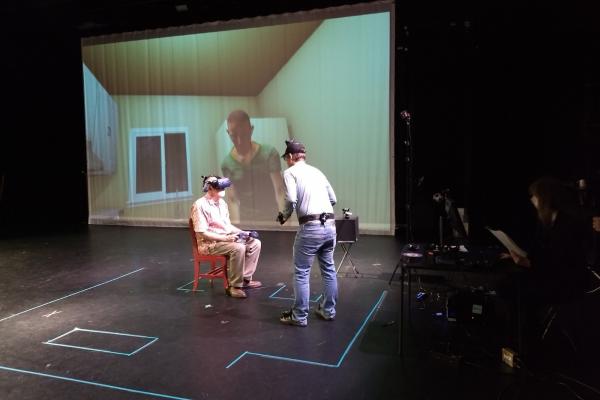 Alex Oliszewski interacts with a volunteer for the Dementia VR patient experience