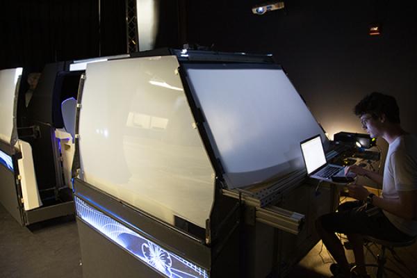 A team member works at his laptop on the autonomous vehicle project