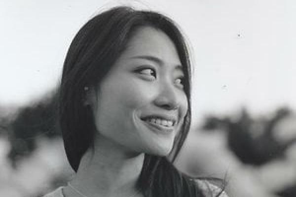 Rosalie Yu Smiling woman looking away from camera