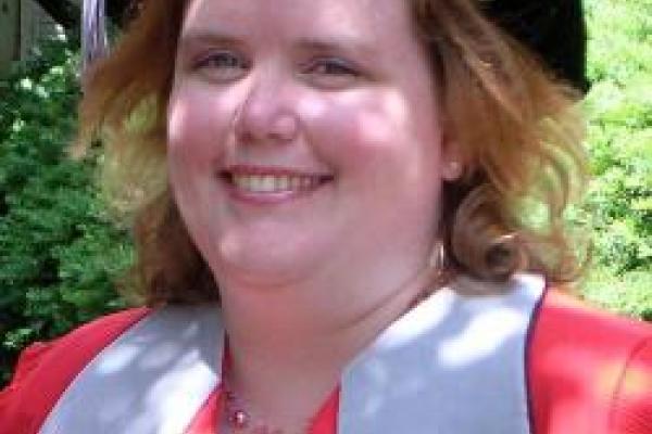 Katie Whitlock Woman with graduation outfit